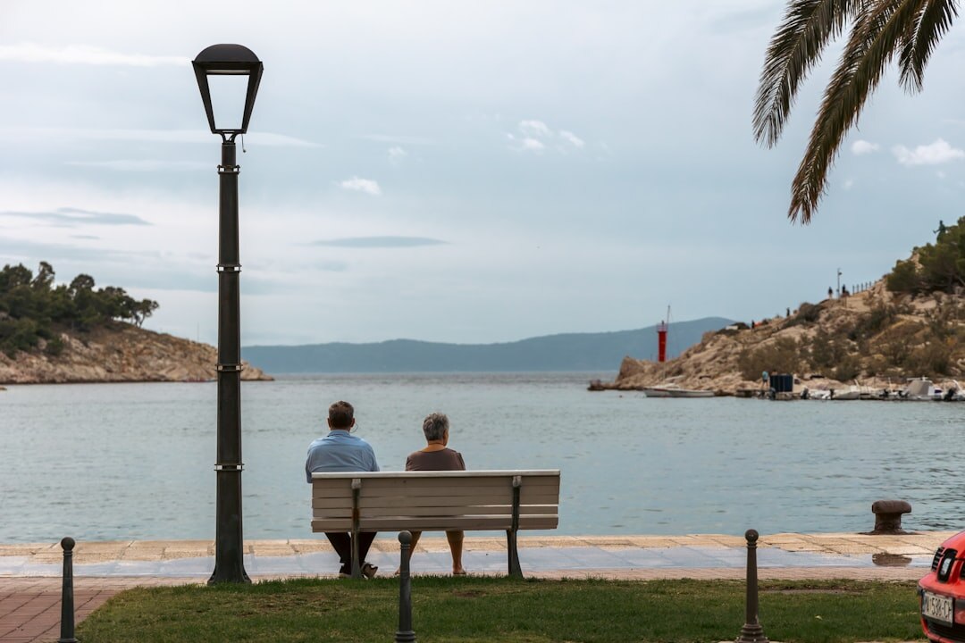 Group of Croatian seniors sitting together outdoors enjoying a social gathering