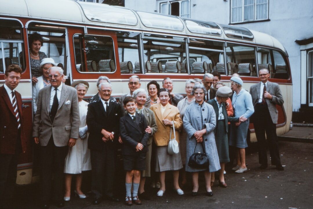 Group of seniors boarding a tour bus for a day trip