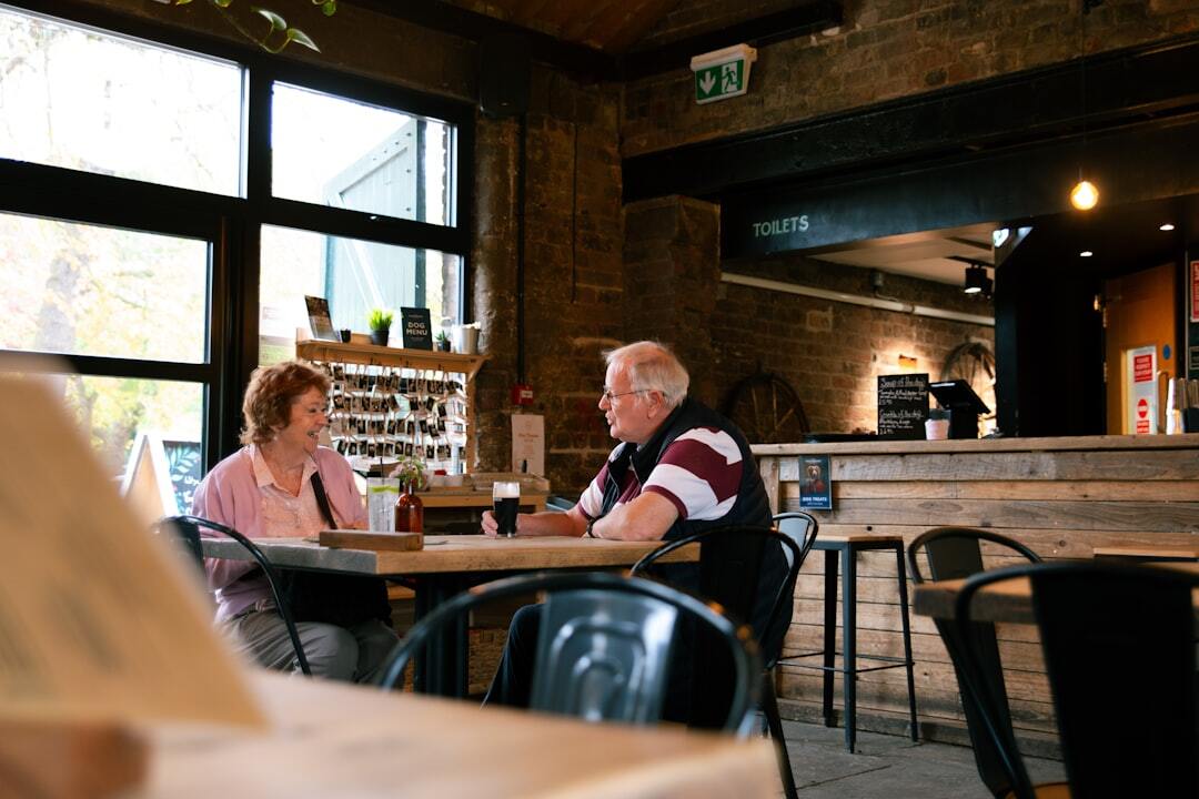 Seniors gathered around a table enjoying coffee and conversation