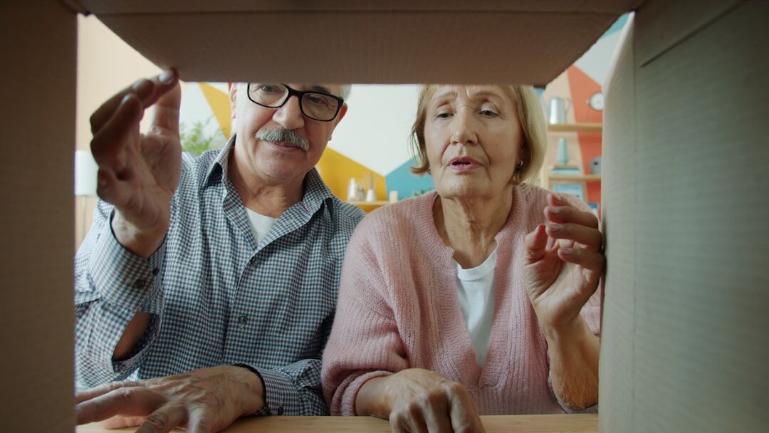 senior couple packing luggage